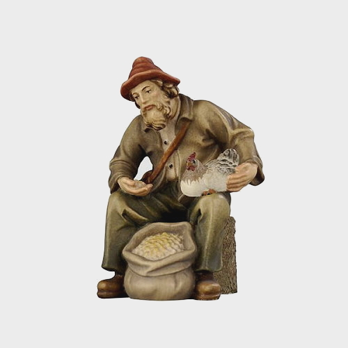 Rainell 037 Krippenfigur Hirte sitzend mit Futtersack und Henne
